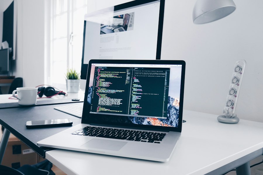 A laptop displaying source code in a professional development workspace
